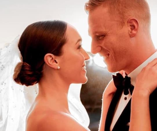 Bride and groom smiling close together