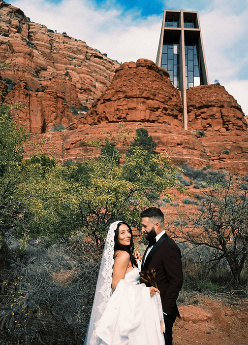 Couple embracing before the red rocks of Sedona