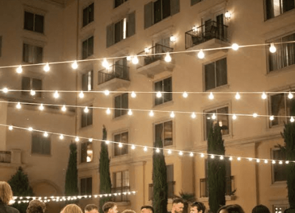 Bride and groom toasting with raised glasses at their sweetheart table