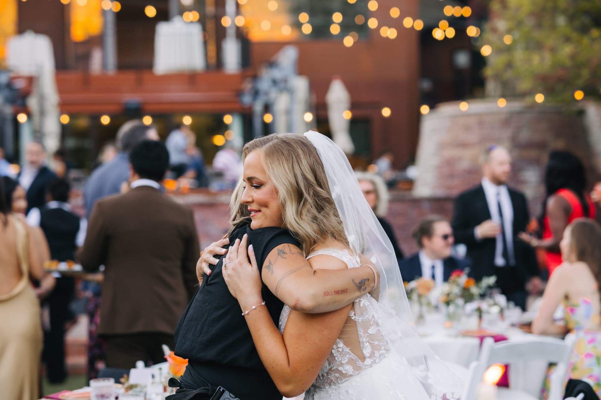 A bride hugging Arabella at the reception