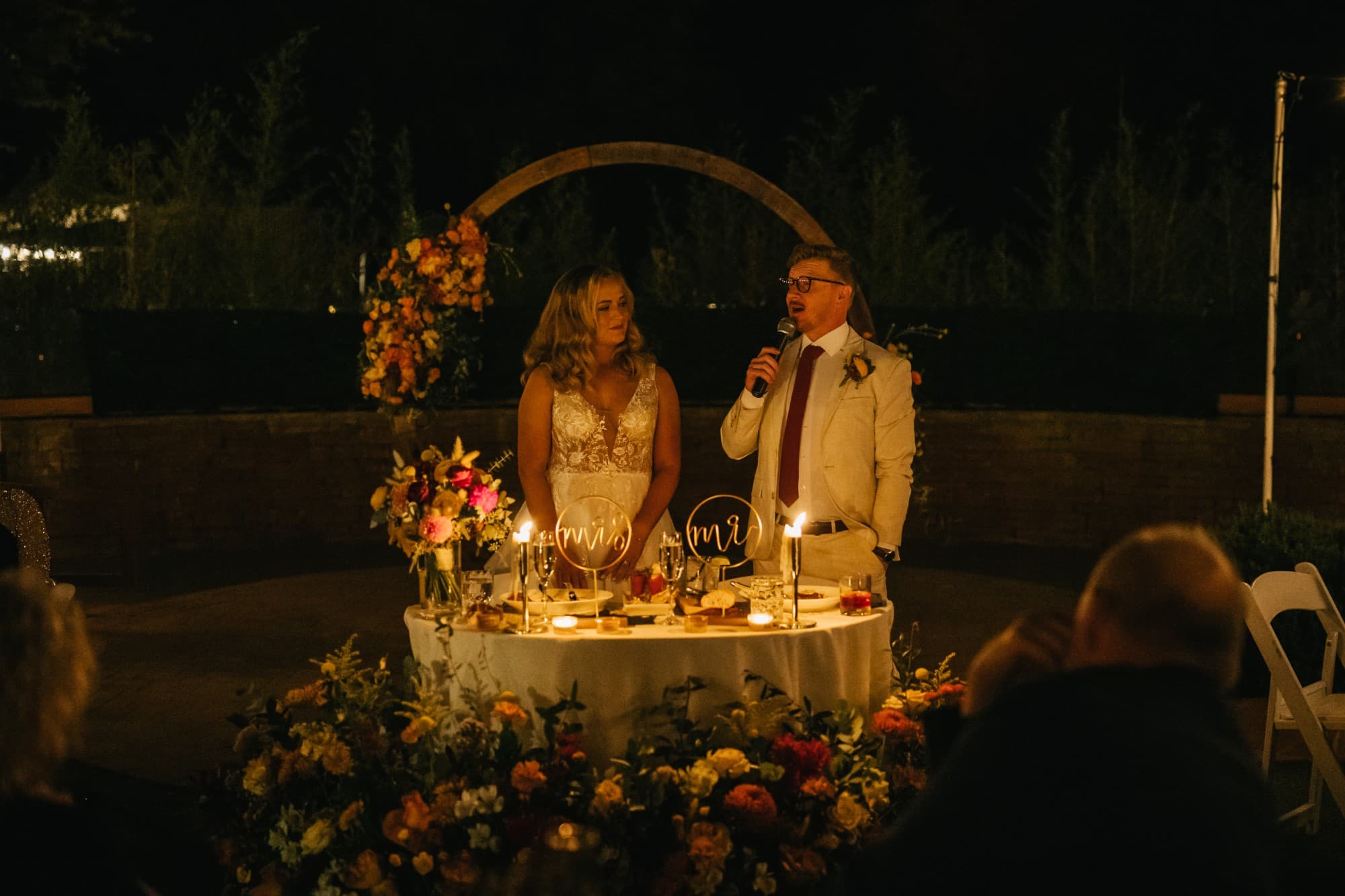 Derek giving a toast at the candlelit sweetheart table