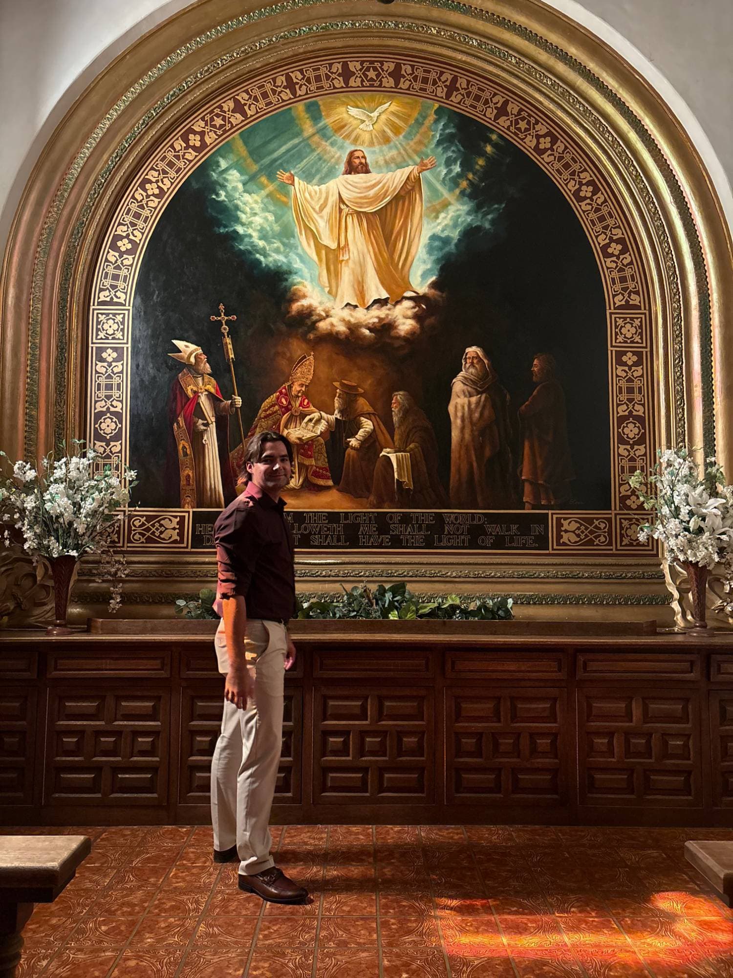 Malu Russell standing before the painted altar of the Tlaquepaque chapel