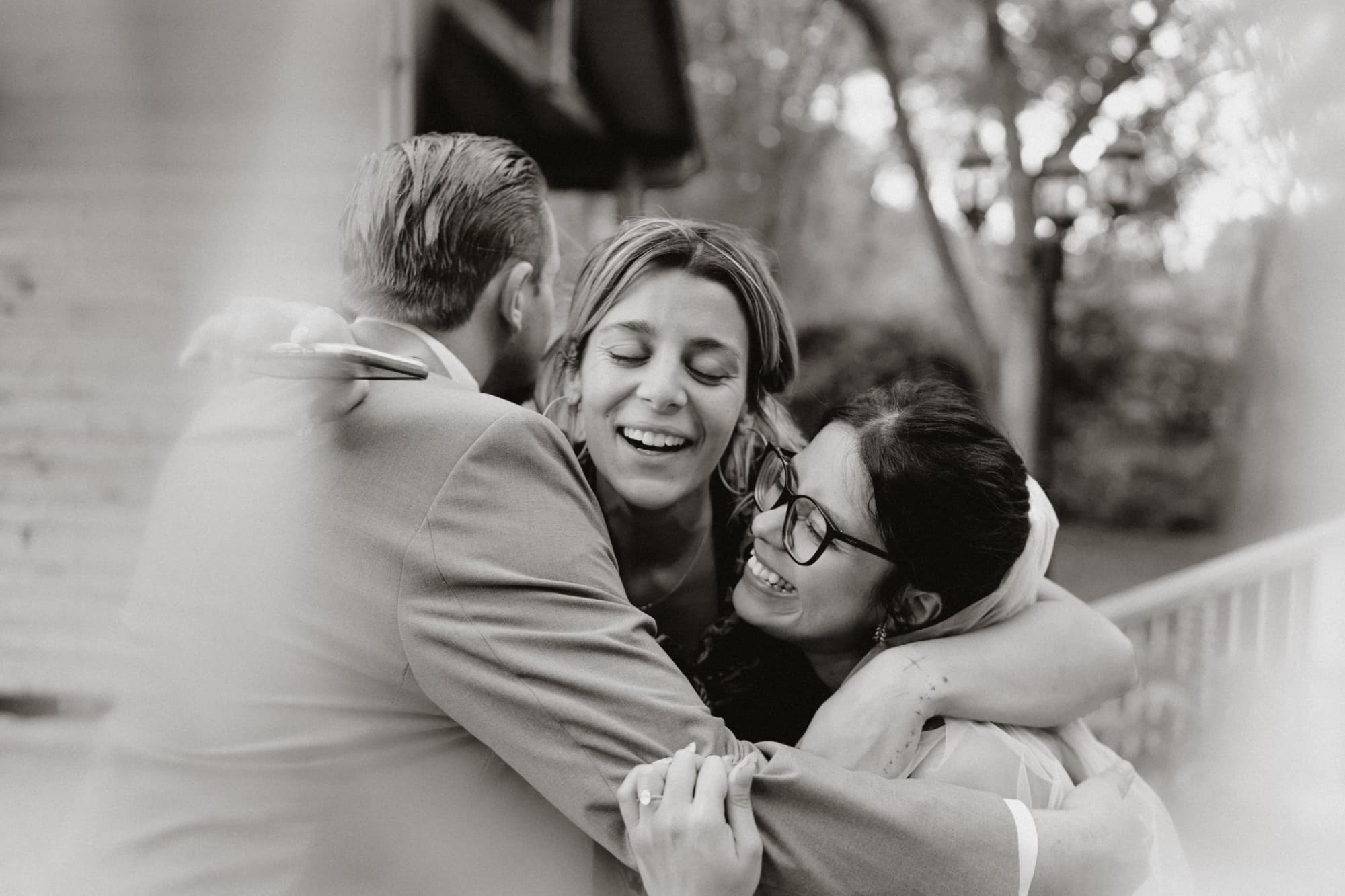 A joyful three-way hug with Patricia and Drew, in black and white