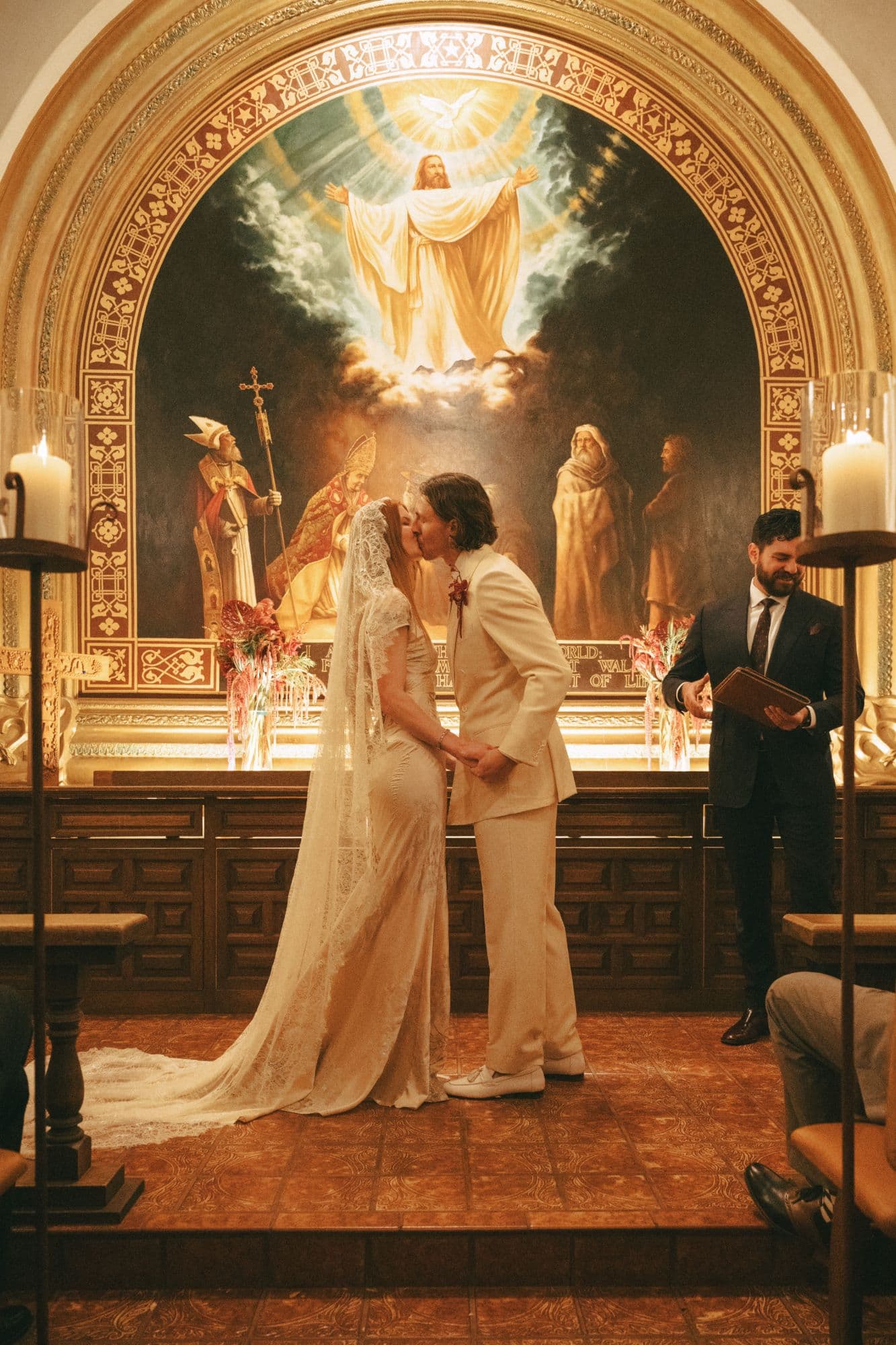 Bride and groom's first kiss at the candlelit altar of the Tlaquepaque chapel in Sedona